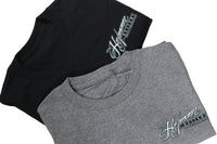 Two folded t-shirts, one black and one gray, with a brand logo on a light background.